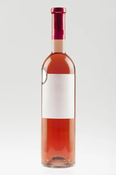 Red wine bottle with empty label and sticker — Stock Photo, Image