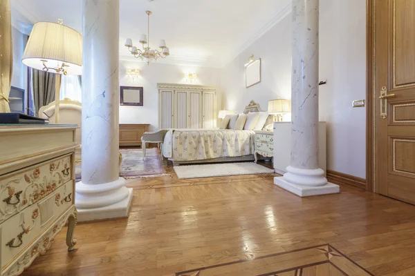 Interior of a classic style luxury bedroom with marble pillars — Stock Photo, Image