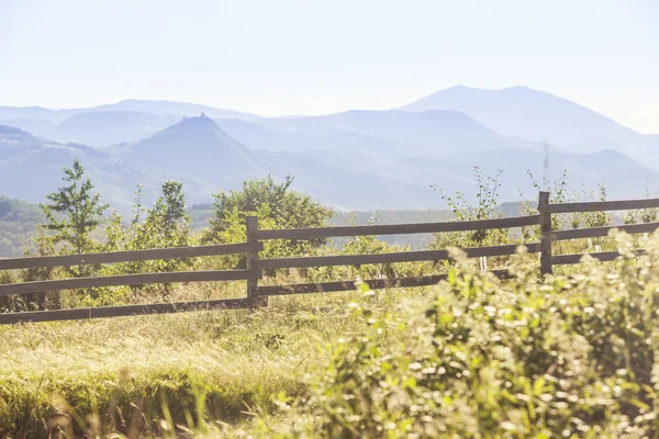 View at the mountains over a wooden fence — Stock Photo, Image