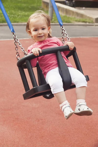 Cute little girl on a swing — Stock Photo, Image