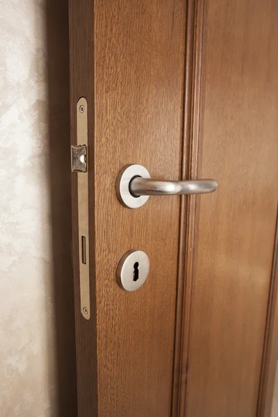 Doorknob and lock on wooden door — Stock Photo, Image