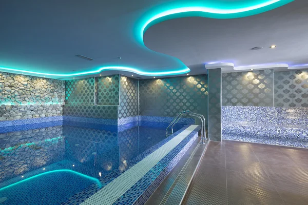 Piscine intérieure avec lumières colorées au centre de spa — Photo