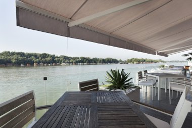 Modern riverside cafe terrace clipart