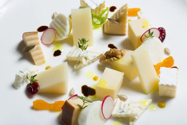 Assortment of cheeses with radish and nuts — Stock Photo, Image