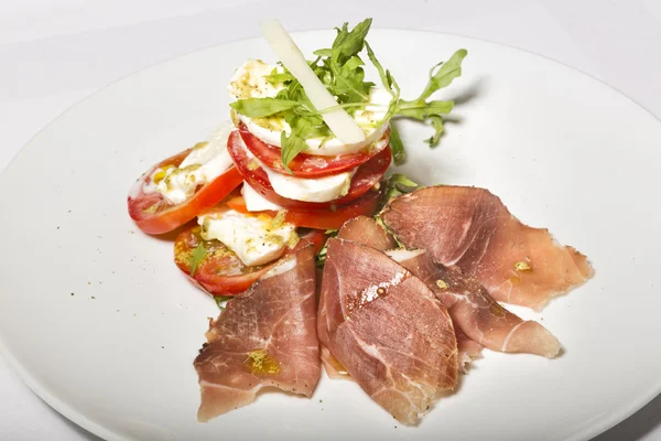 Caprese salad and prosciutto — Stock Photo, Image