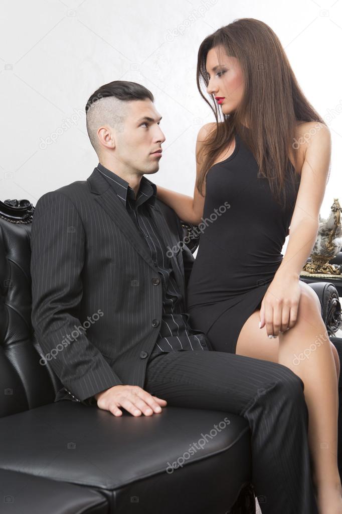 Attractive couple on leather sofa
