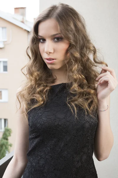 Retrato de uma mulher bonita em vestido preto — Fotografia de Stock