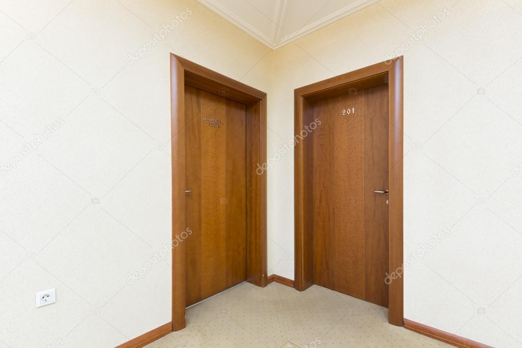 Hotel room entrance - two brown wooden doors