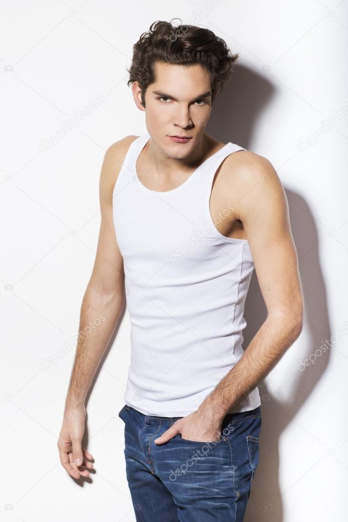 Portrait of a handsome man in tank top and jeans