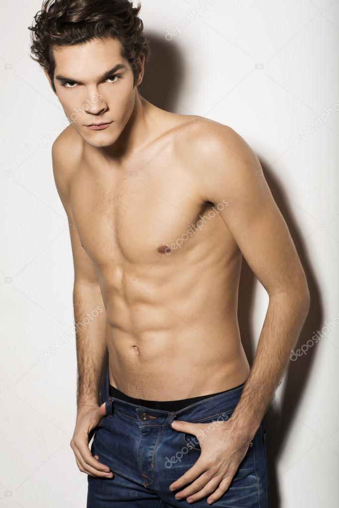 Handsome shirtless man in jeans