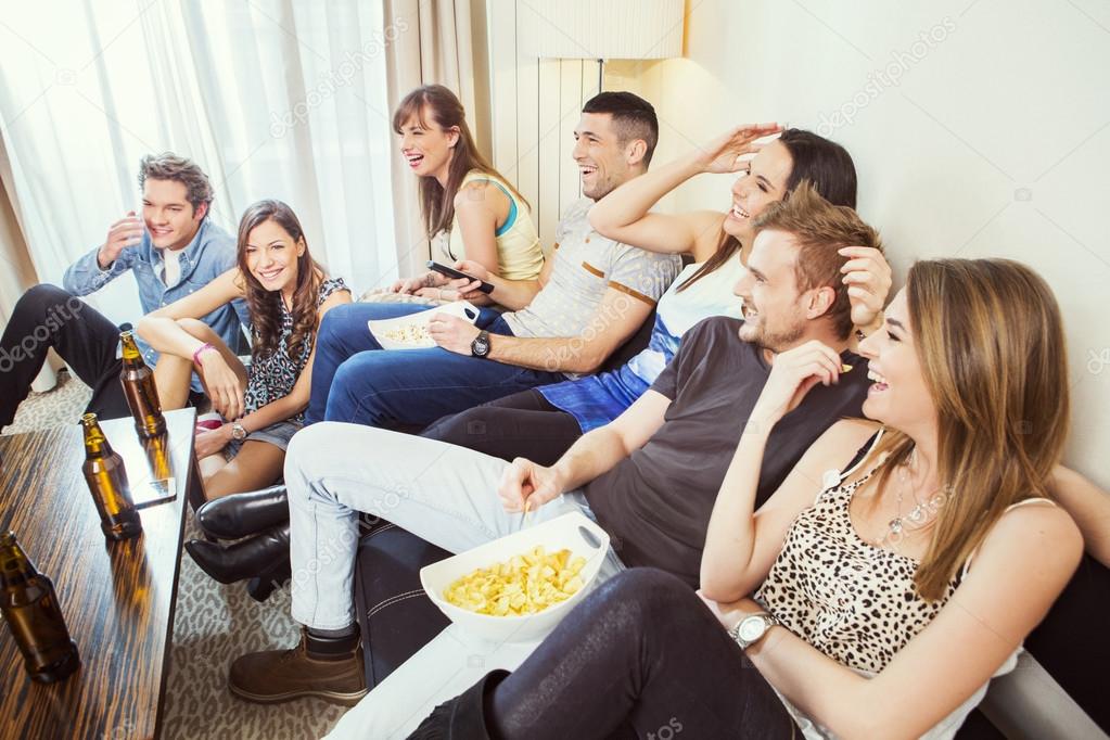 Group of friends watching TV at home