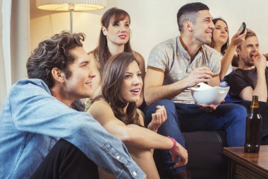 Group of friends watching TV at home clipart