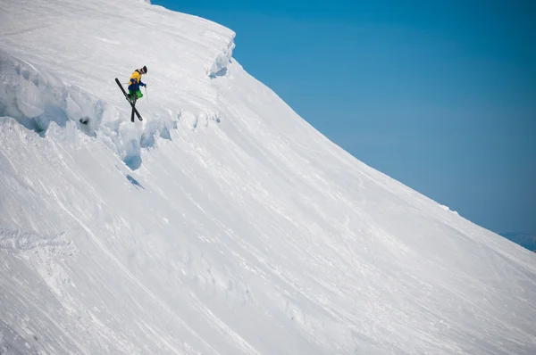 Jumping skier at  mountains Stock Photo