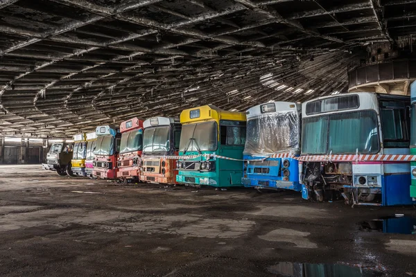 Abandoned bus depot with amazing construction circus and colored buses