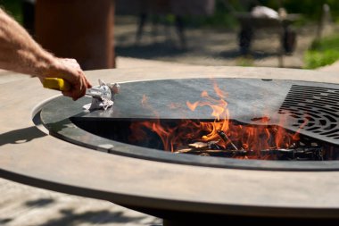 Tencere dibin kara seninki benden kara, seninki benden kara. Yuvarlak masa pişirme yüzeyi. Arka bahçede paslanmaz çelik ızgaralı barbekü ızgarası hazır ızgara yemeği. İçinde alevler olan ızgara..