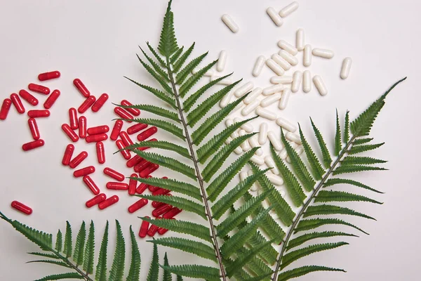 Muitas pílulas de cápsula branca e vermelha em um fundo colorido. Suplementos de saúde e medicamentos — Fotografia de Stock