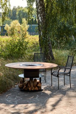 Demir Şebeke 'li Kettle Grill Pit. Yakacak odunlu yuvarlak masa pişirme yüzeyi. Arka bahçede paslanmaz çelik ızgaralı barbekü ızgarası hazır ızgara yemeği. İçinde alevler olan ızgara..