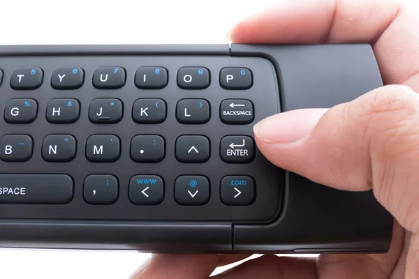 Hand holding mini wirless keyboard and push enter key button ove — Stock Photo, Image