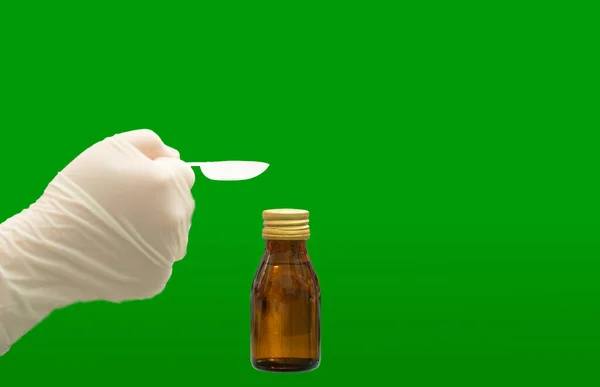 Glove Hand Hold Teaspoon Medicine Syrup Bottle Isolated Green Background — Stock Photo, Image