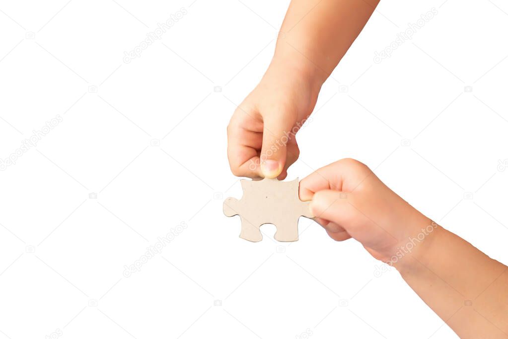 kid fingers holding the jigsaw that complete in success business concept