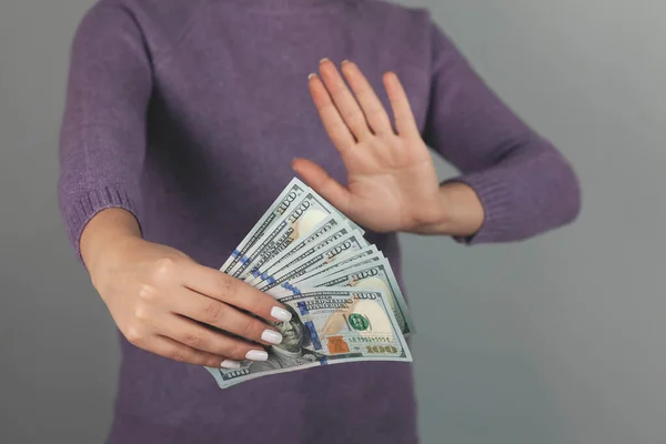 young woman hand stop sign on money