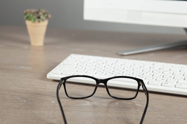 glasses on the computer   keyboard on the desk