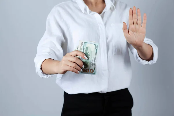 young woman hand stop sign in money