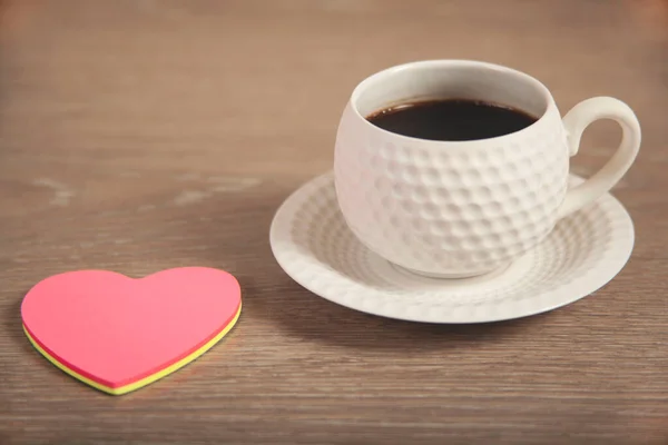 pink hearts on cup of coffee on desk