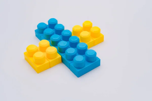 Blue Yellow Lego Block Cross Grey Background — Stock Photo, Image