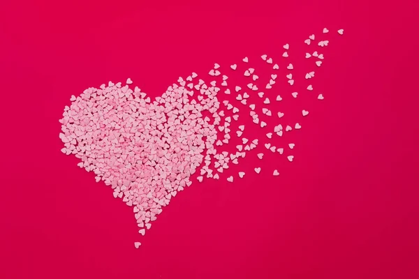 Big heart made of small hearts on red background. Love, wedding and Valentine's day concept