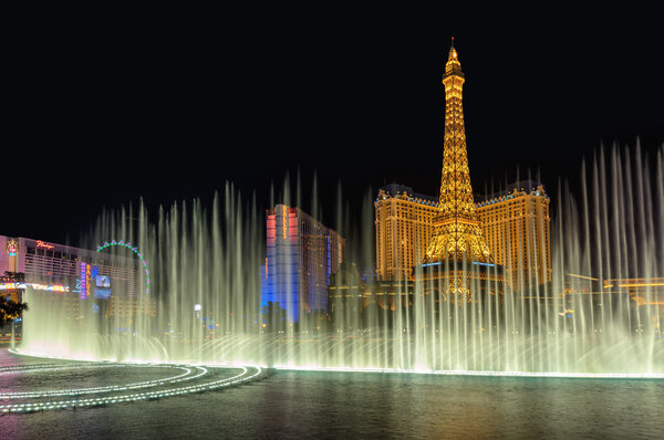 Las Vegas, NV - MARCH 26, 2015 - Bellagio Fountain and Paris hotel, Night illumination on Las Vegas Strip, Nevada,  March 26, 2015