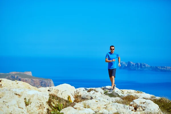 Hombre corriendo sobre la roca — Foto de Stock