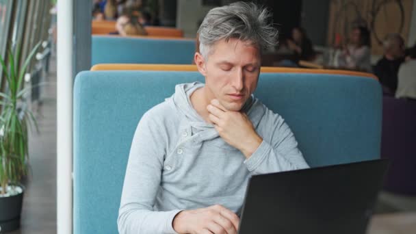 Hombre de aspecto enfermo utilizando ordenador portátil — Vídeo de stock