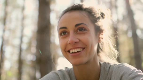 Close up happy young woman laughs in woods — Stock Video