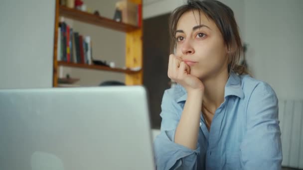 Thoughtful concerned woman working on laptop computer at home — Stock Video