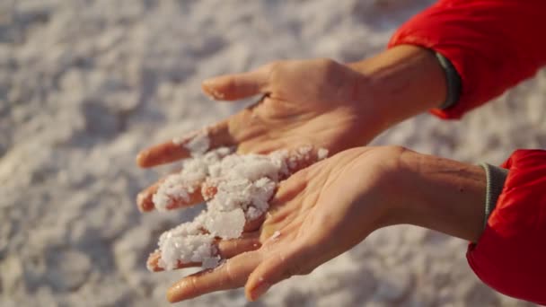 Vrouwen hand met gekristalliseerde zoutvlokken natuurlijke minerale vorming — Stockvideo