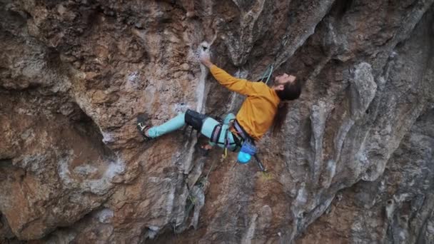 Hombre fuerte escalador escalador escalando por encima de la ruta de roca, haciendo un movimiento duro y cayendo. — Vídeos de Stock