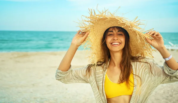 Muotokuva onnellinen kirkas kesä nainen kaunis hymy iso olki hattu rannalla — kuvapankkivalokuva