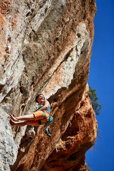 Rock climber climbing up a cliff — Stock Photo, Image