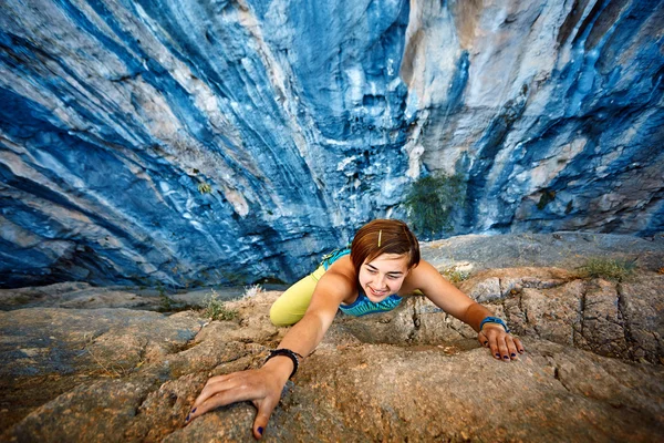 stock image Rock climber climbing up a cliff