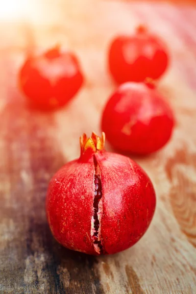 Pomegranates on a dark wooden background — Stock Photo, Image