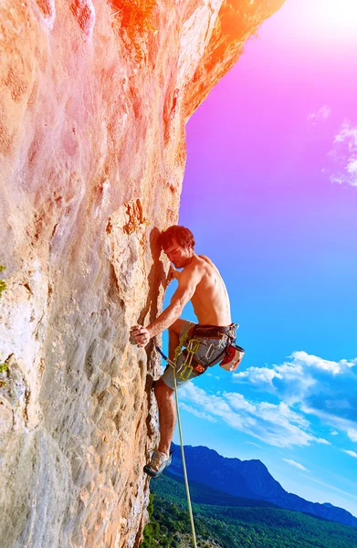 Rock climber climbing up a cliff — Stock Photo, Image