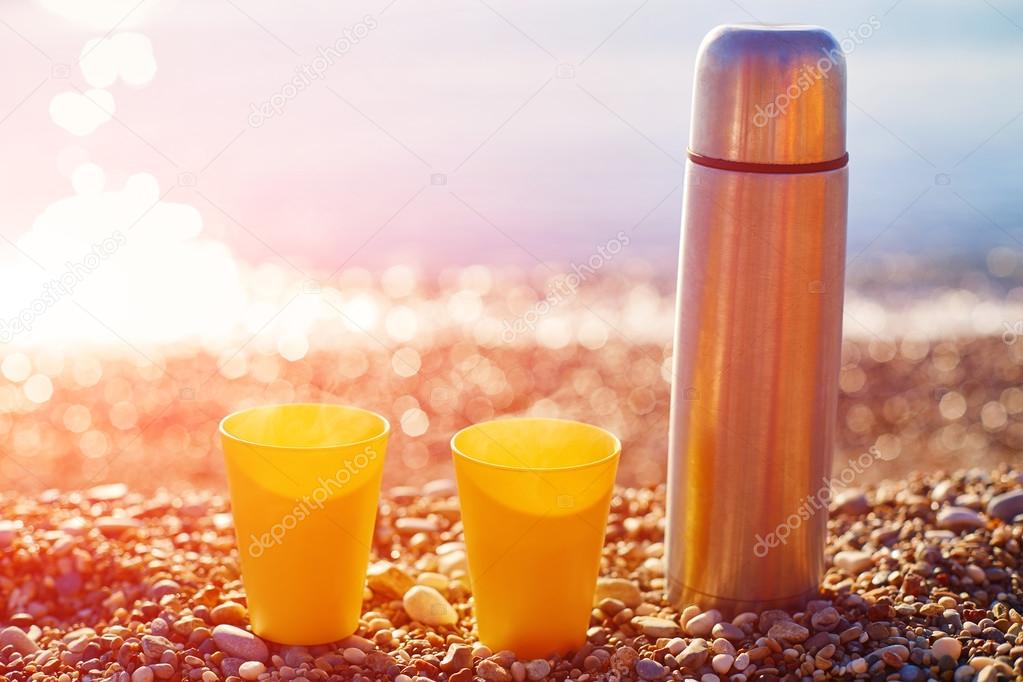 two yellow cups on a sunny beach
