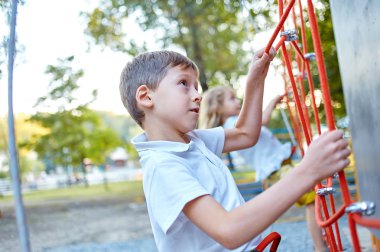 Little boy in  rock climbing gym