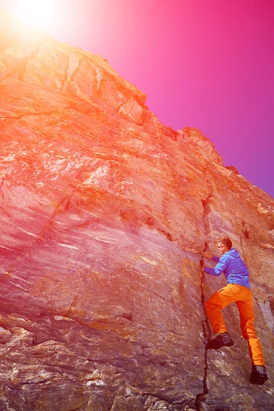 Climber climbing up a cliff — Stock Photo, Image