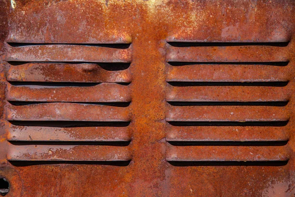 Rusty metal grilles, painted with paint and peeled off from old age, ventilation holes for air ingress in industrial facilities, an electric shield, an opening door — Stock Image Rusty Metal Grilles Painted Paint Peeled Old Age Ventilation Holes Royalty Free Stock Photos