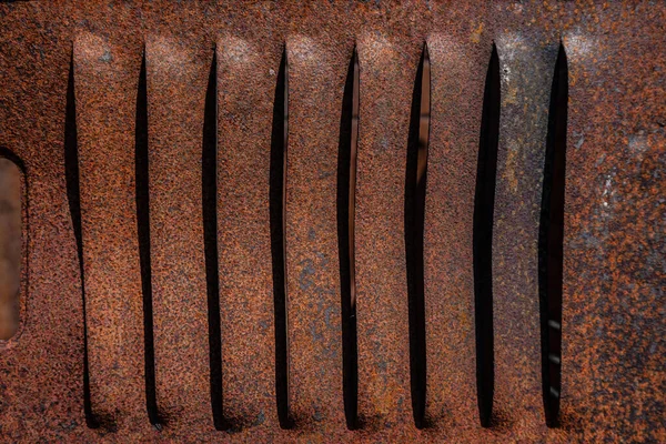 Rusty metal grilles, painted with paint and peeled off from old age, ventilation holes for air ingress in industrial facilities, an electric shield, an opening door — Stock Image Rusty Metal Grilles Painted Paint Peeled Old Age Ventilation Holes Stock Photo