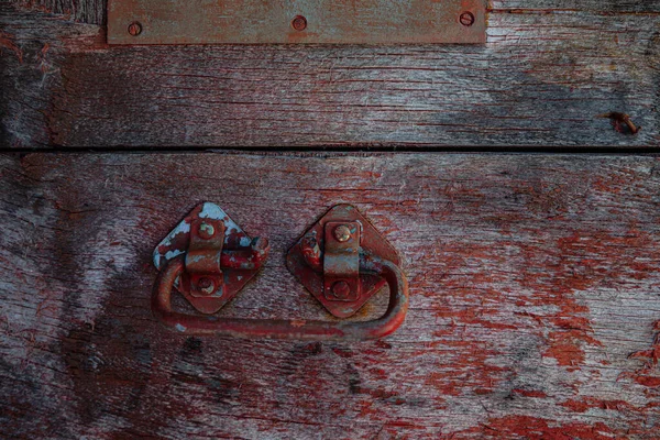 Wooden surface of the box, rusty metal parts, painted with paint and peeled off from old age, holes, nails in the base, an opening door. Screensaver background — Stock Image Wooden Surface Box Rusty Metal Parts Painted Paint Peeled Old Royalty Free Stock Photos