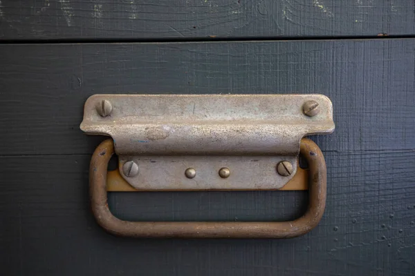 Wooden surface of the box, rusty metal parts, painted with paint and peeled off from old age, holes, nails in the base, an opening door. Screensaver background — Stock Image Wooden Surface Box Rusty Metal Parts Painted Paint Peeled Old Royalty Free Stock Images