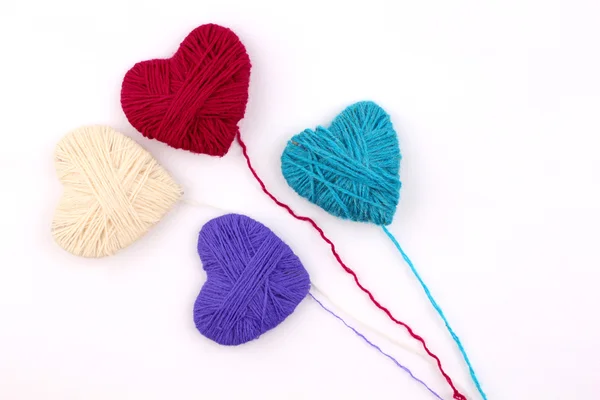 Heart wool yarn in coils with knitting needles — Stock Photo, Image